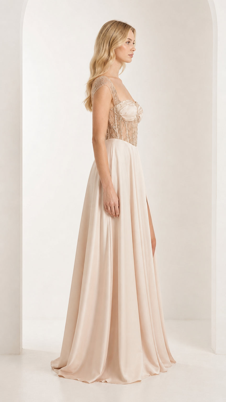 Side profile of champagne evening dress with thigh split