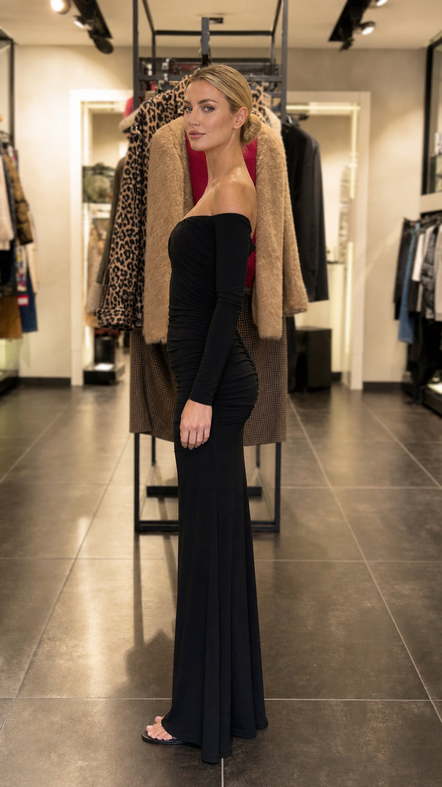 Side profile of model in black evening dress