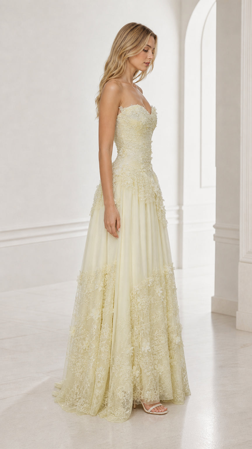 Side view of yellow strapless floral applique ball gown