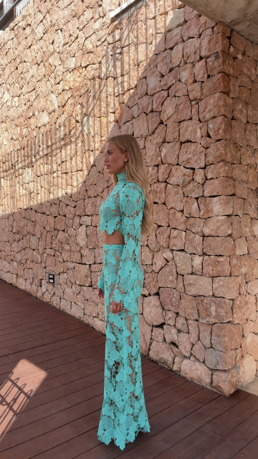 Side profile view of model in turquoise crochet set