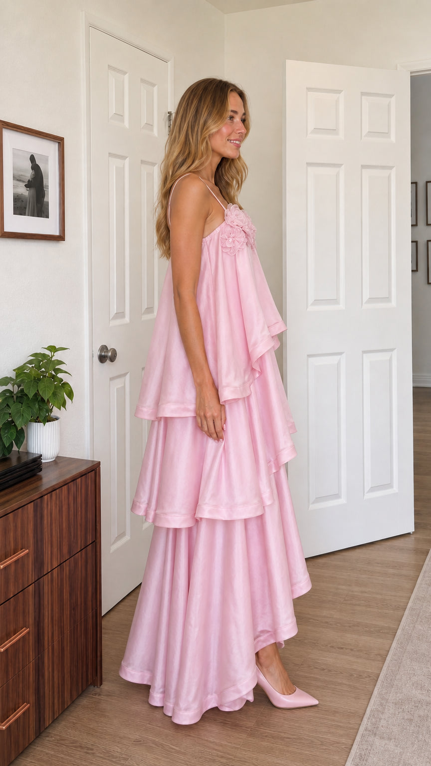 Side profile of model in pink tiered maxi dress