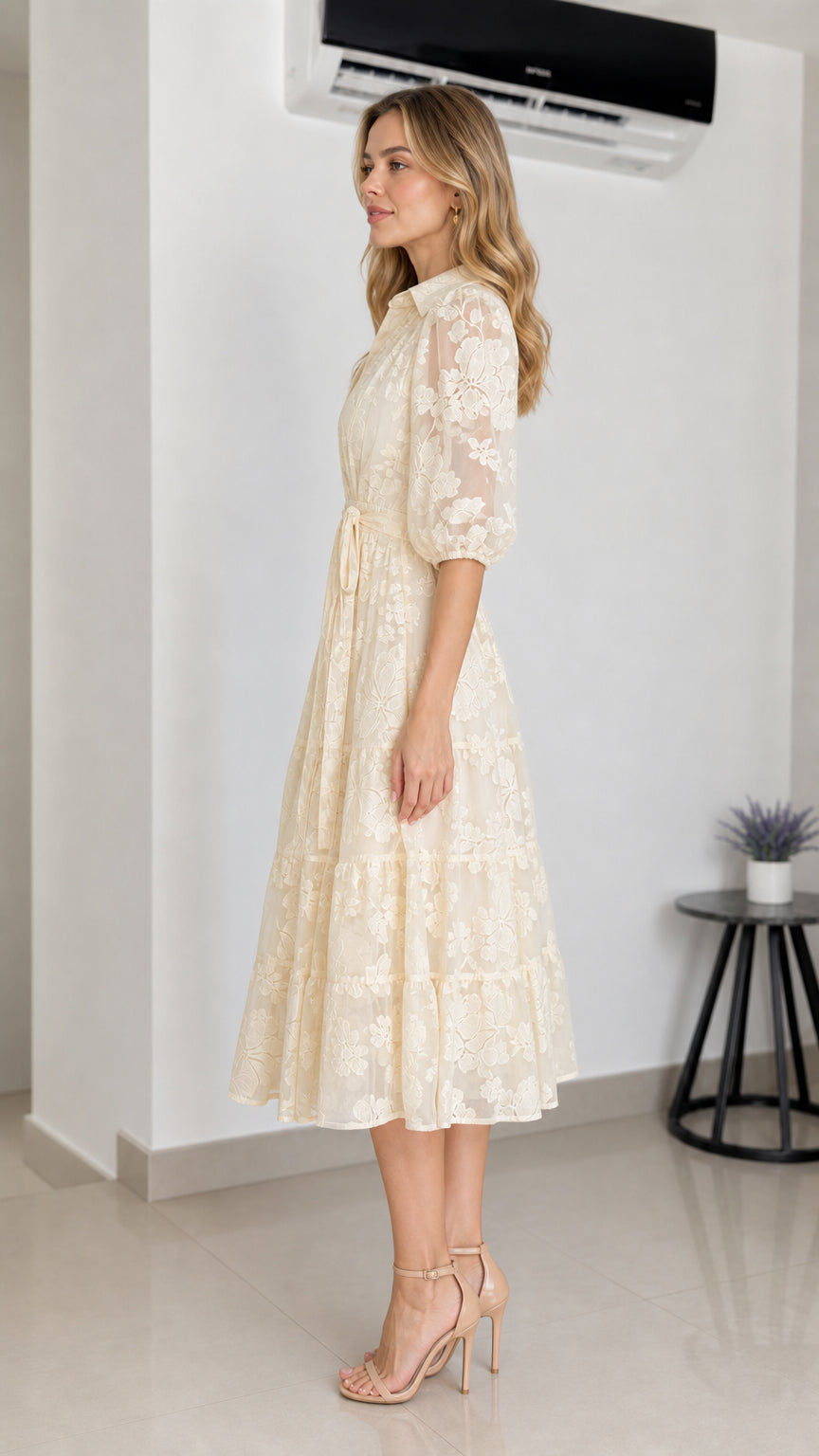 Side profile view of cream midi dress on model