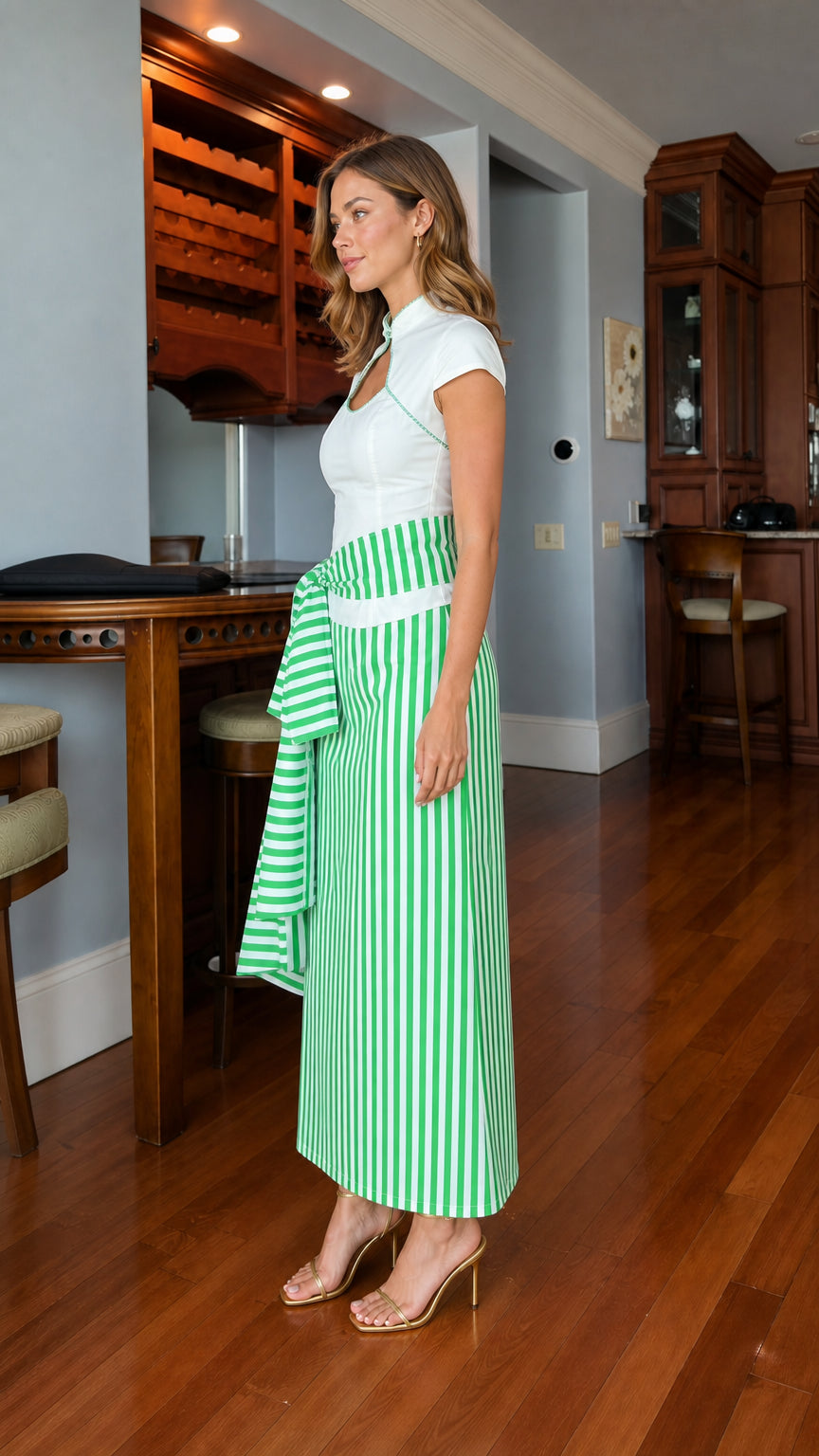 Model wearing white and green striped dress, side profile view
