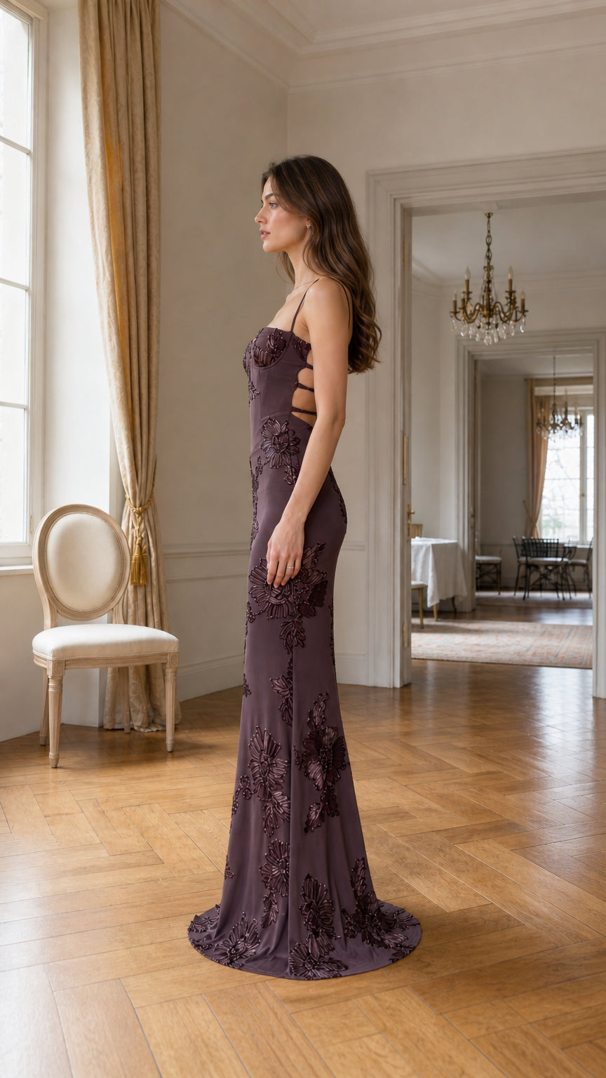 Side profile of burgundy evening gown on model
