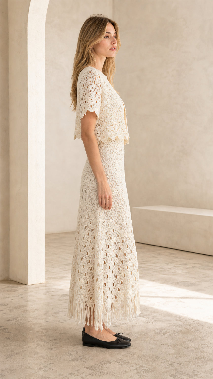 Side profile of ivory crochet lace top and maxi skirt