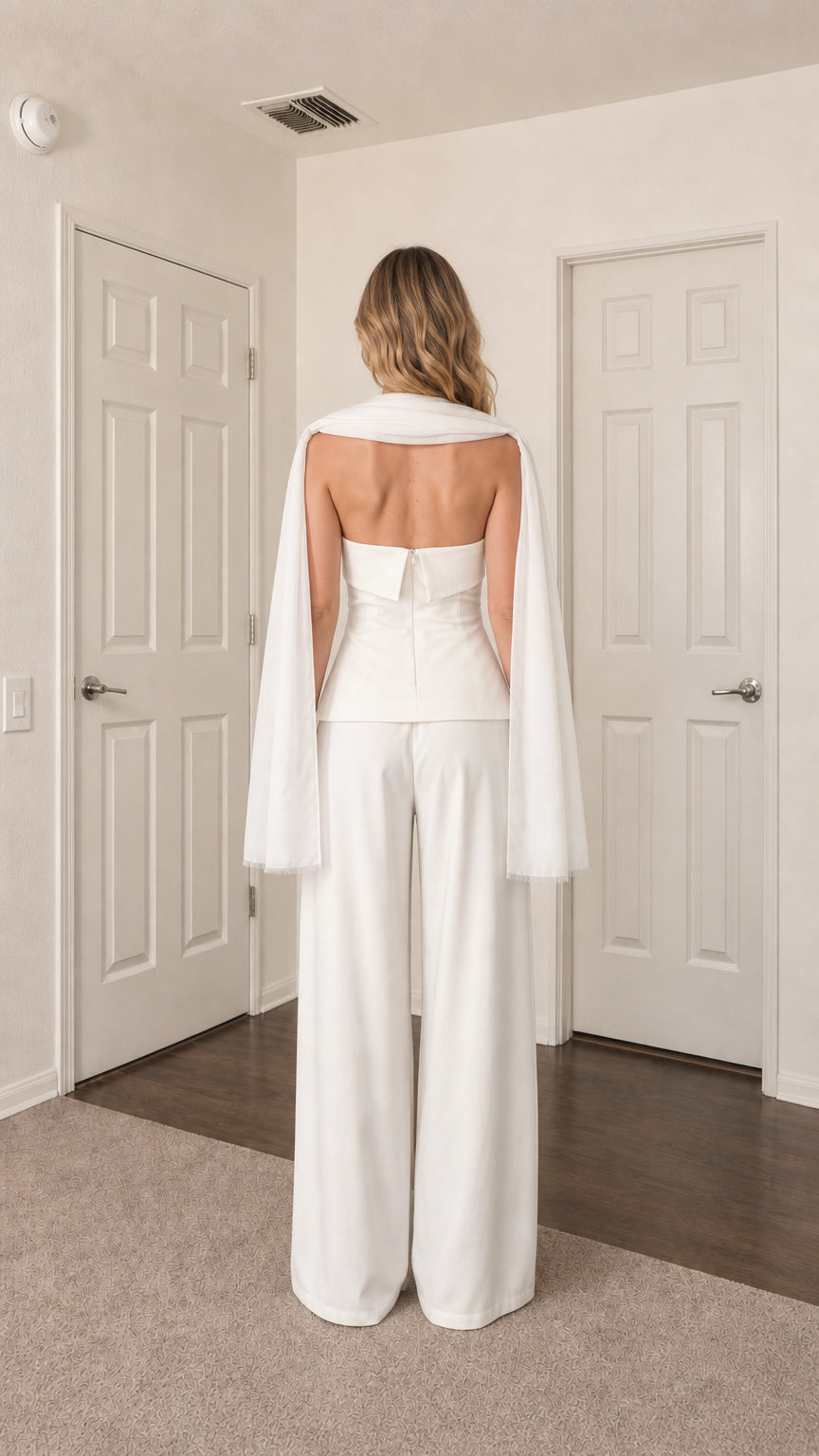 Back view of model in white strapless top and trousers