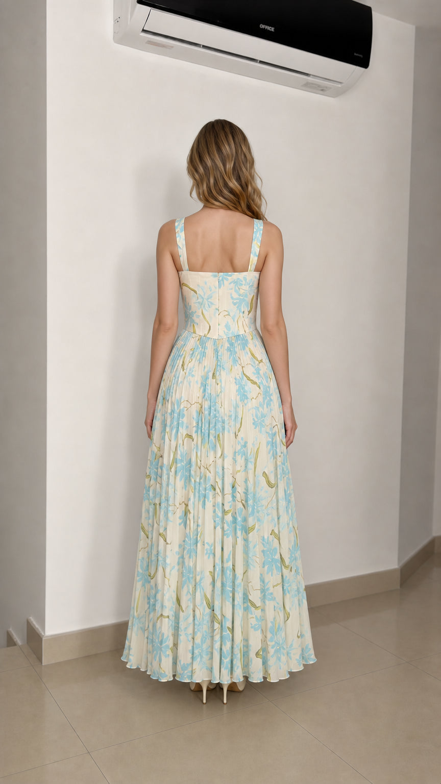 Model wearing ivory floral maxi dress from the back