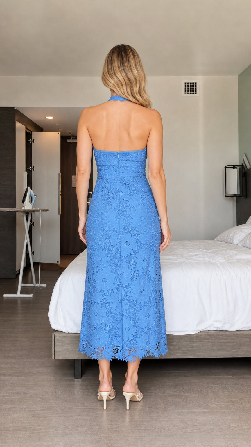 Back view of model wearing blue halter floral lace midi dress