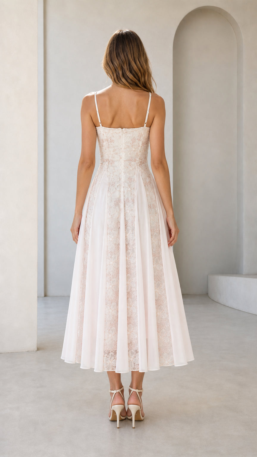 Back view of pink embroidered midi dress showing straps and closure