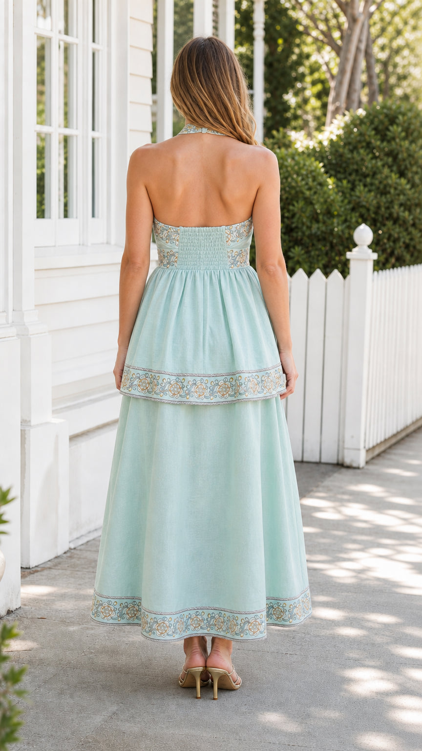 Back view of mint embroidered halter midi dress