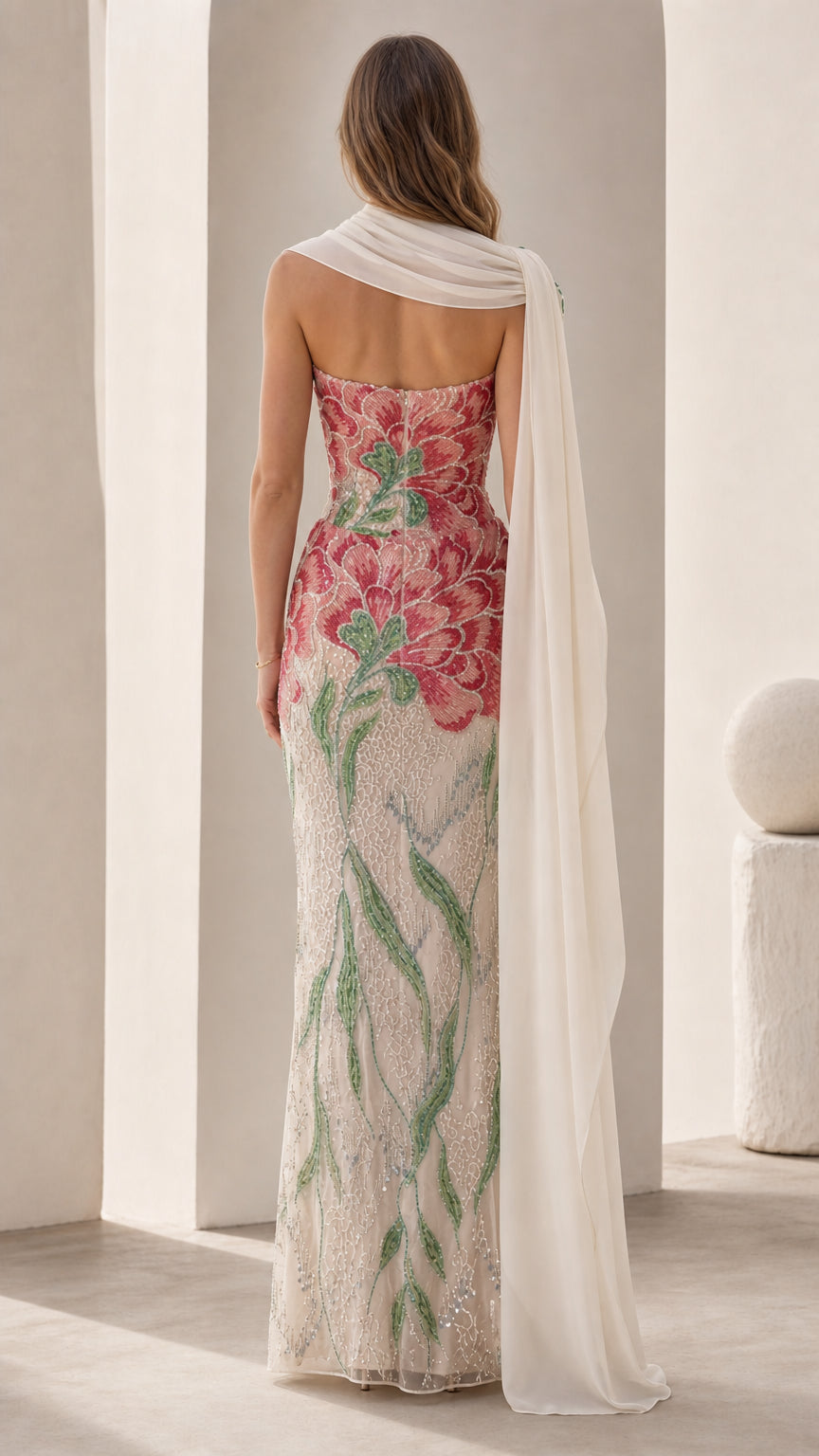 Back view of white embroidered floral strapless evening gown with cape