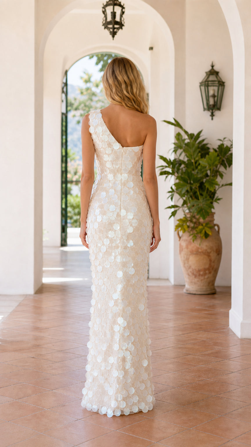 Back view of model in white one-shoulder gown