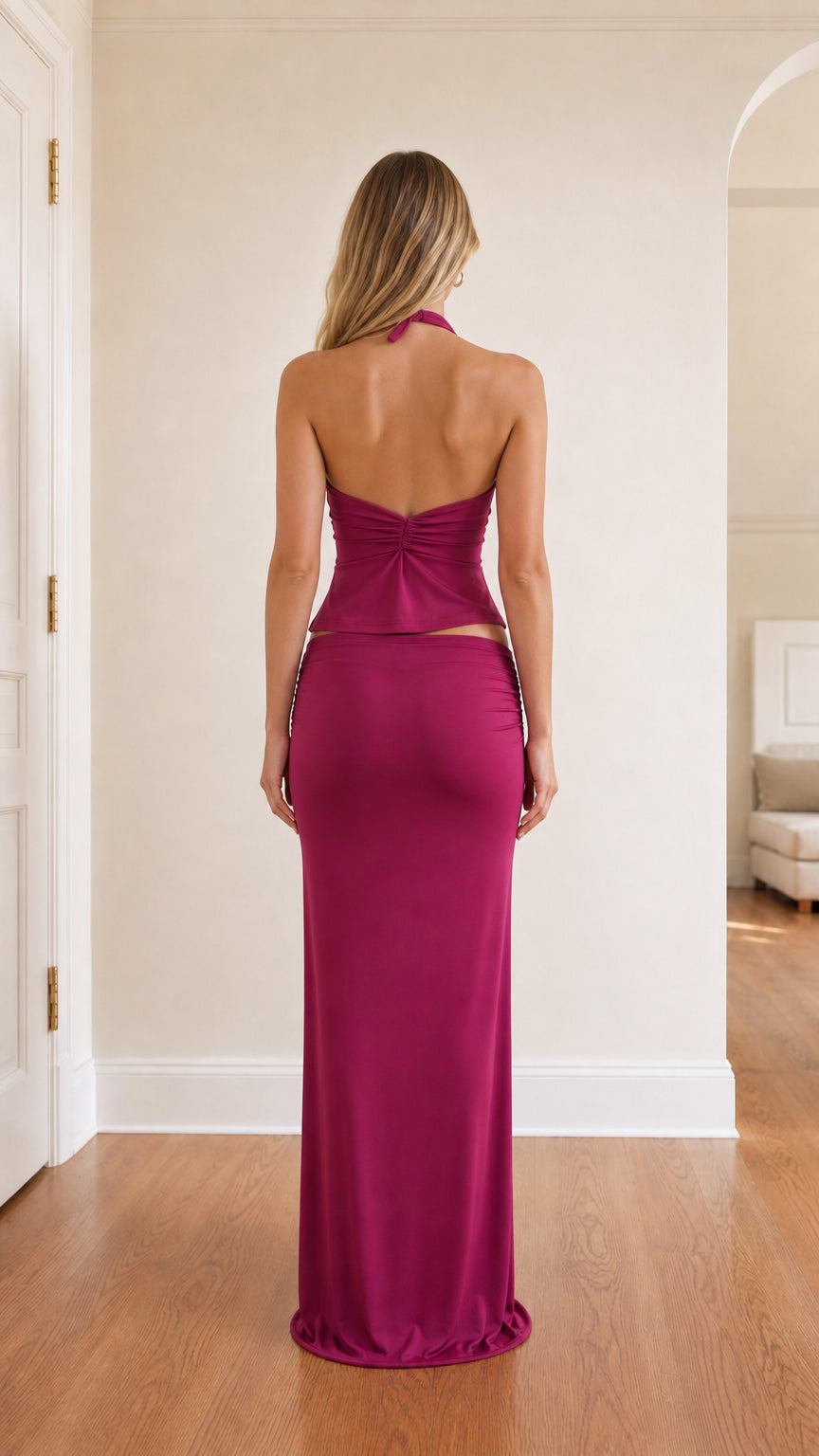 Back view of model in fuchsia halter top and maxi skirt