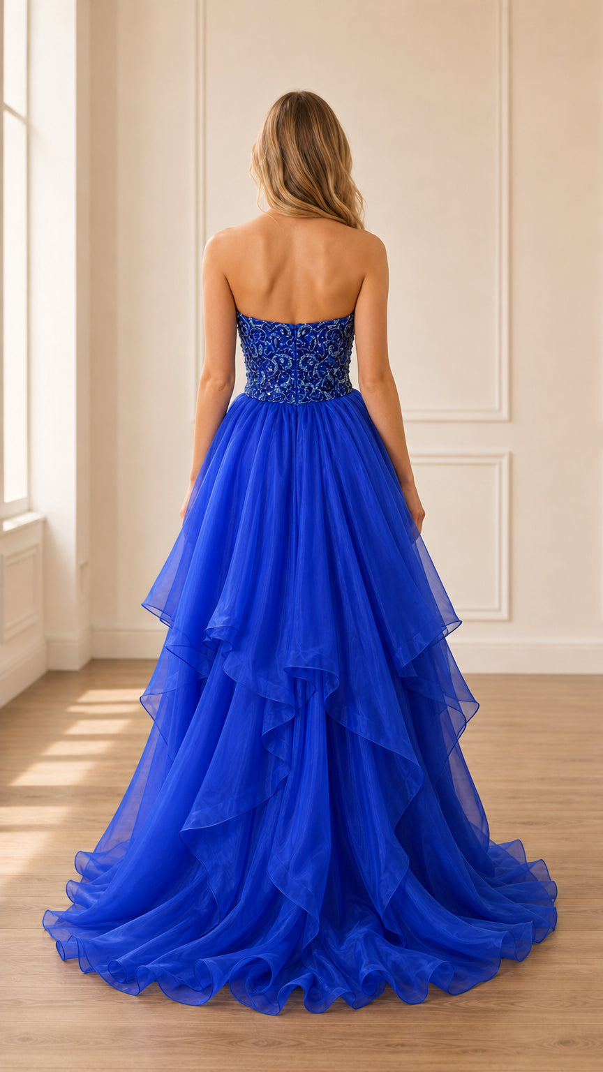Back view showing ruffled tulle skirt of royal blue gown