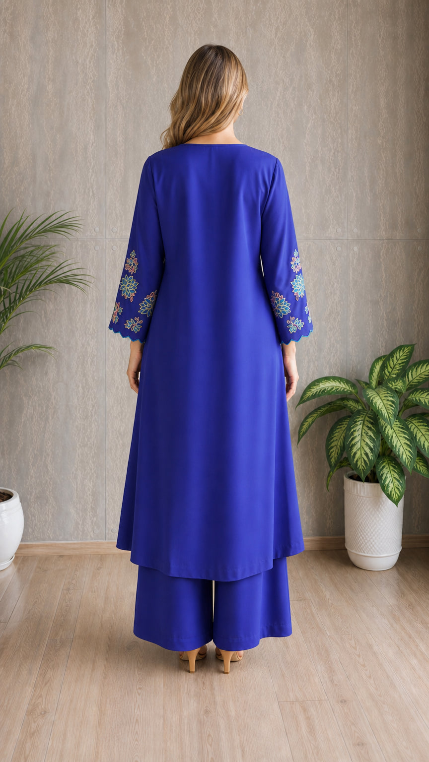 Model wearing royal blue embroidered tunic set, back view
