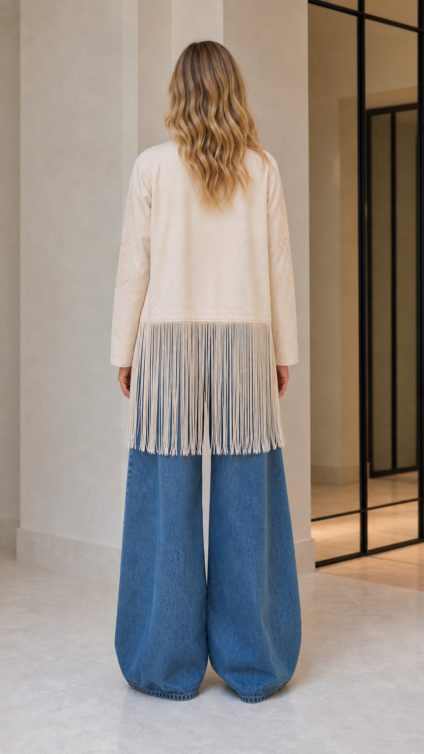 Model wearing beige embroidered fringe jacket, back view