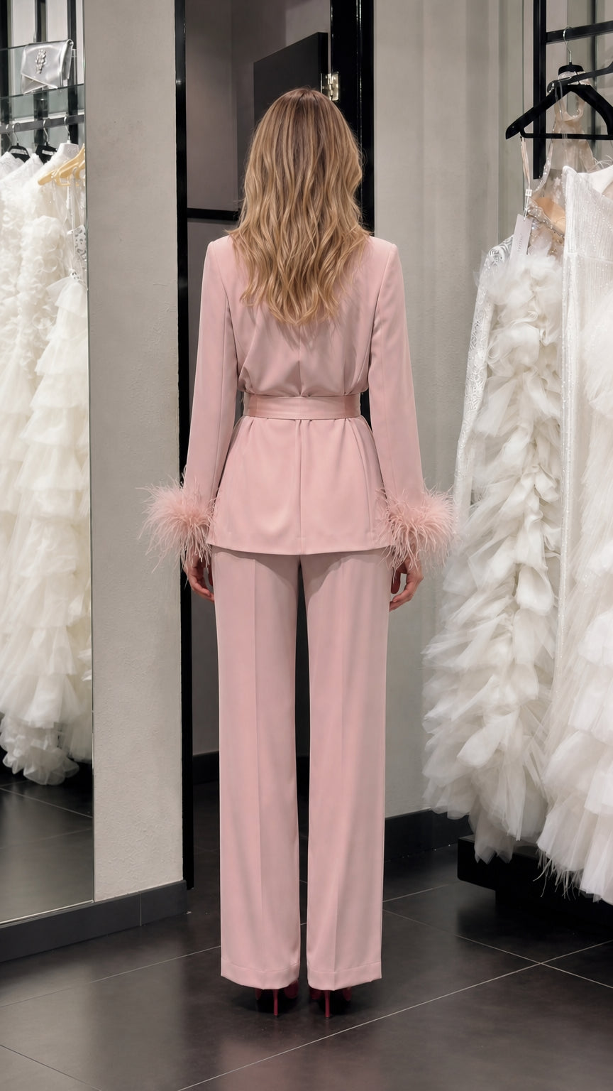 Model wearing pink satin feather cuff pantsuit back view