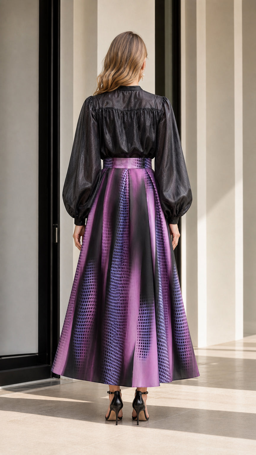 Back view of model wearing black ruffle top and purple gradient skirt
