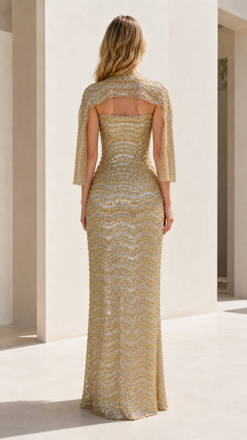 Back view of gold sequin formal gown with shrug capelet