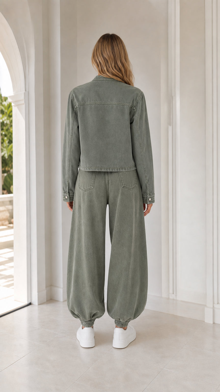 Back view of woman wearing sage green jacket and trousers set