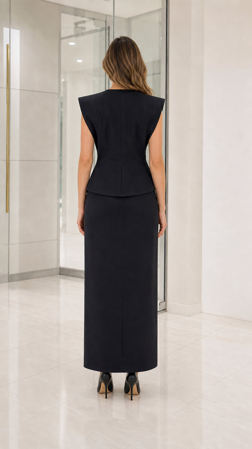 Back view of woman wearing black formal maxi dress