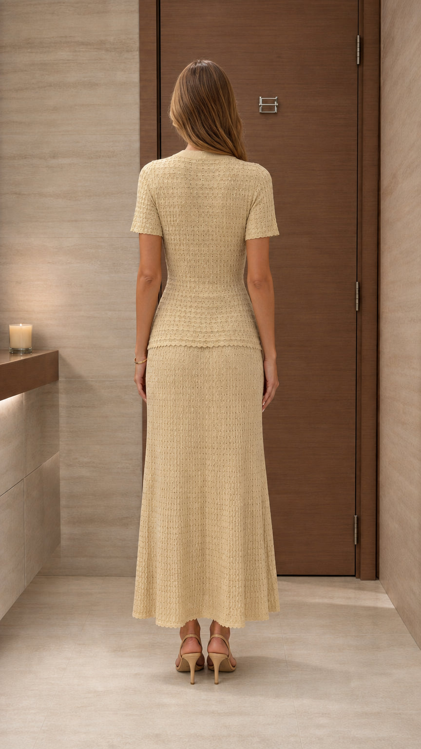 Model wearing beige knit two-piece set from the back