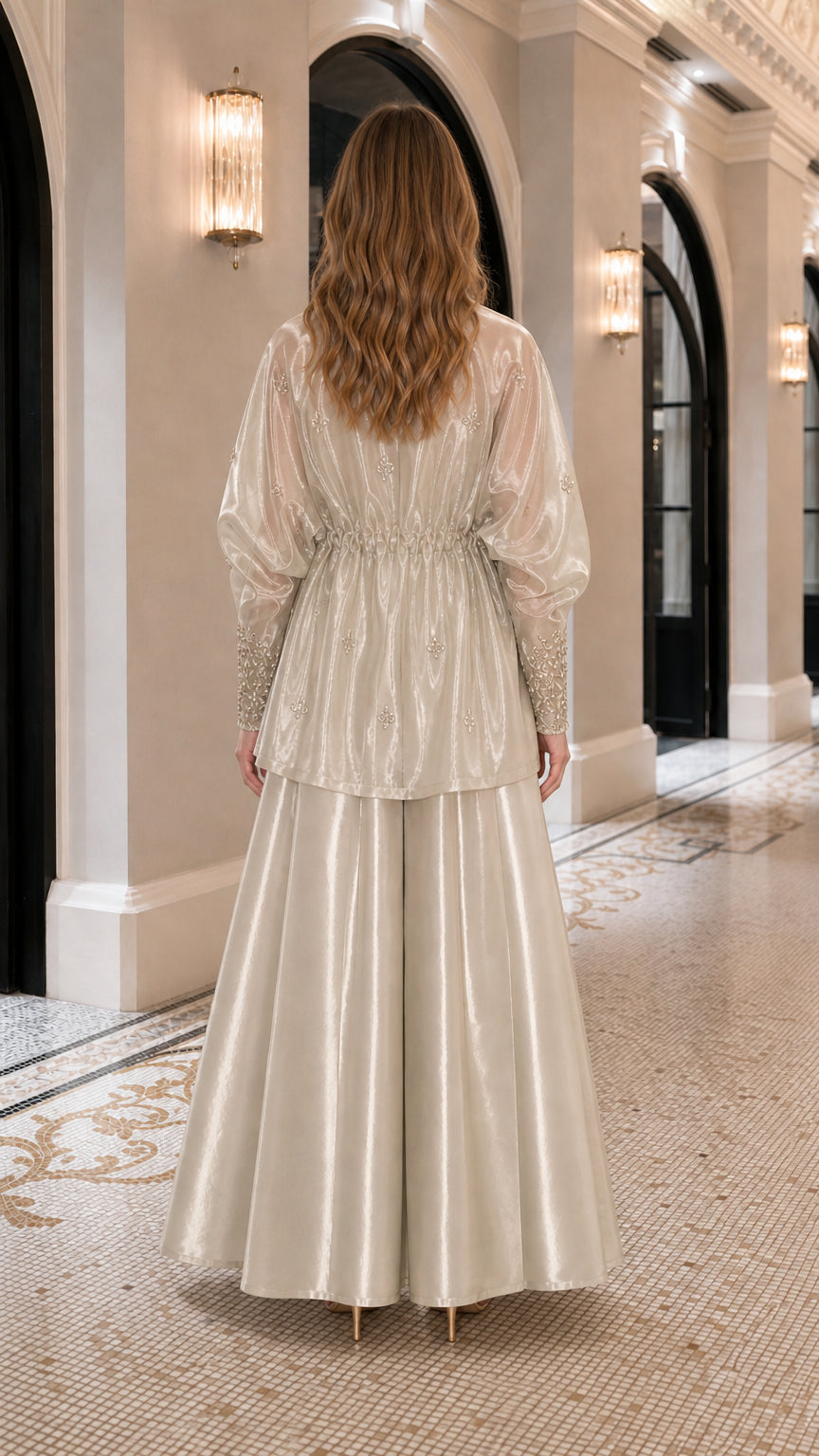 Back view showing fluid drape of champagne wide-leg pants and jacket