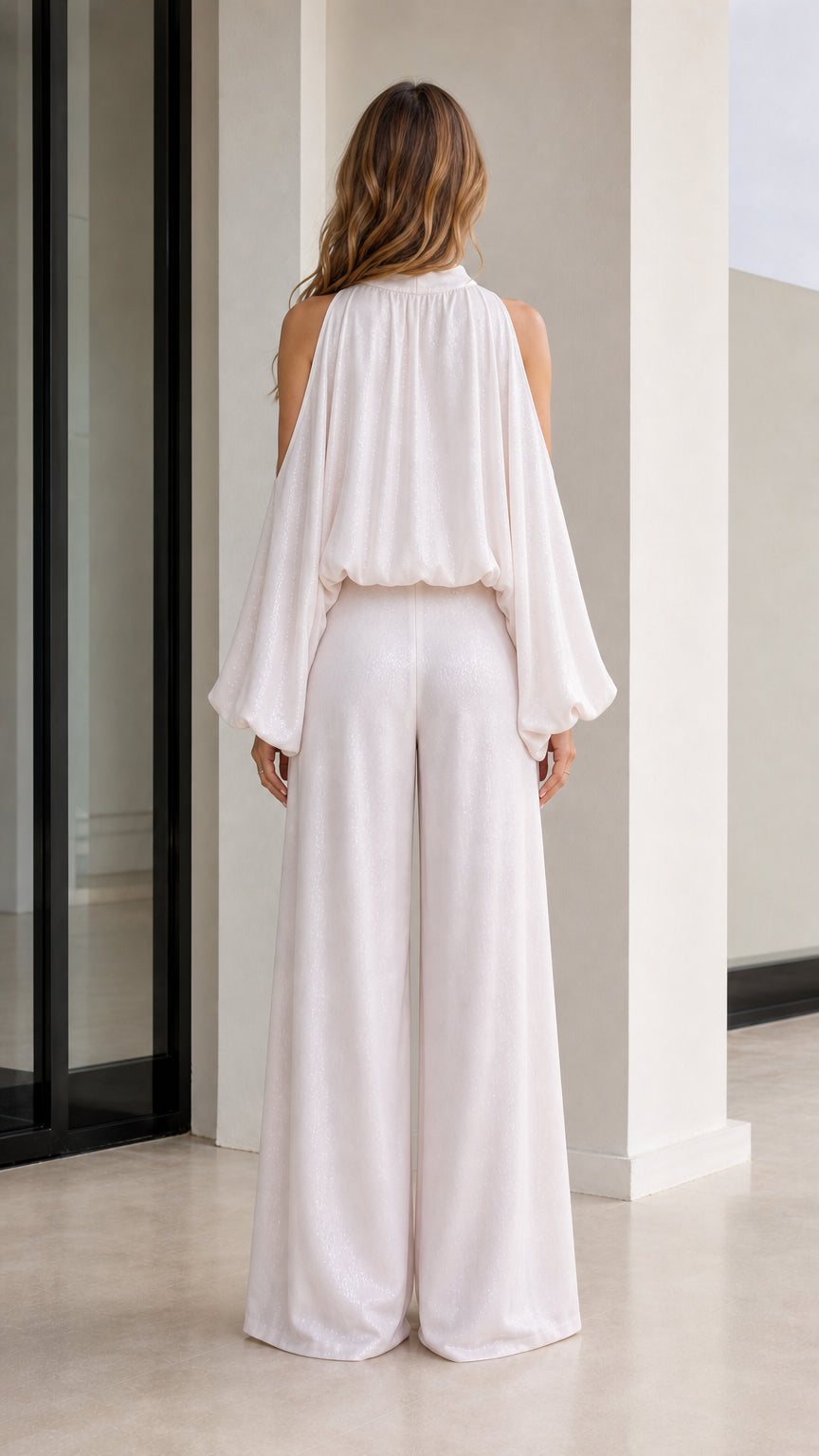 Back view showcasing the flowing cape-like drape of the white blouse