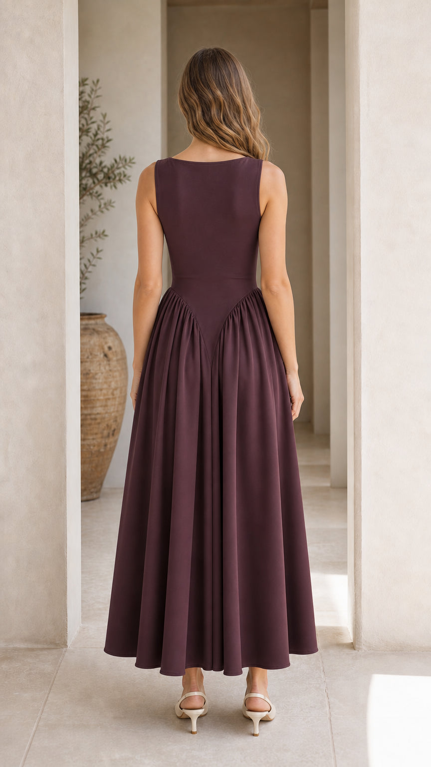 Back view showing gathered skirt detail of burgundy dress