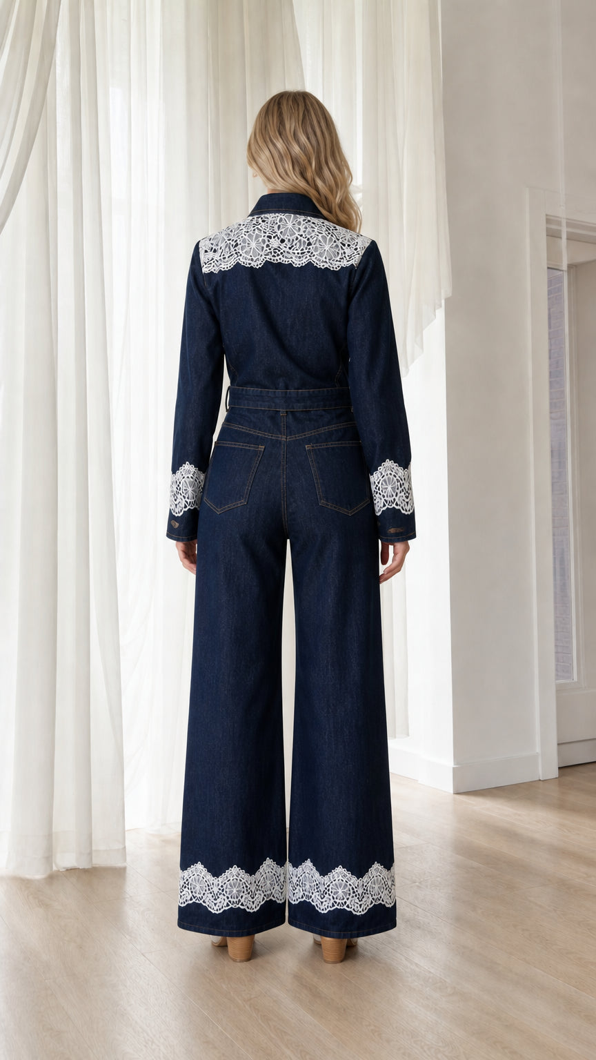 Back view showcasing white lace hem on dark denim jumpsuit