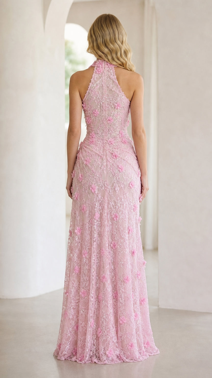 Back view of pink halter evening gown with floral details