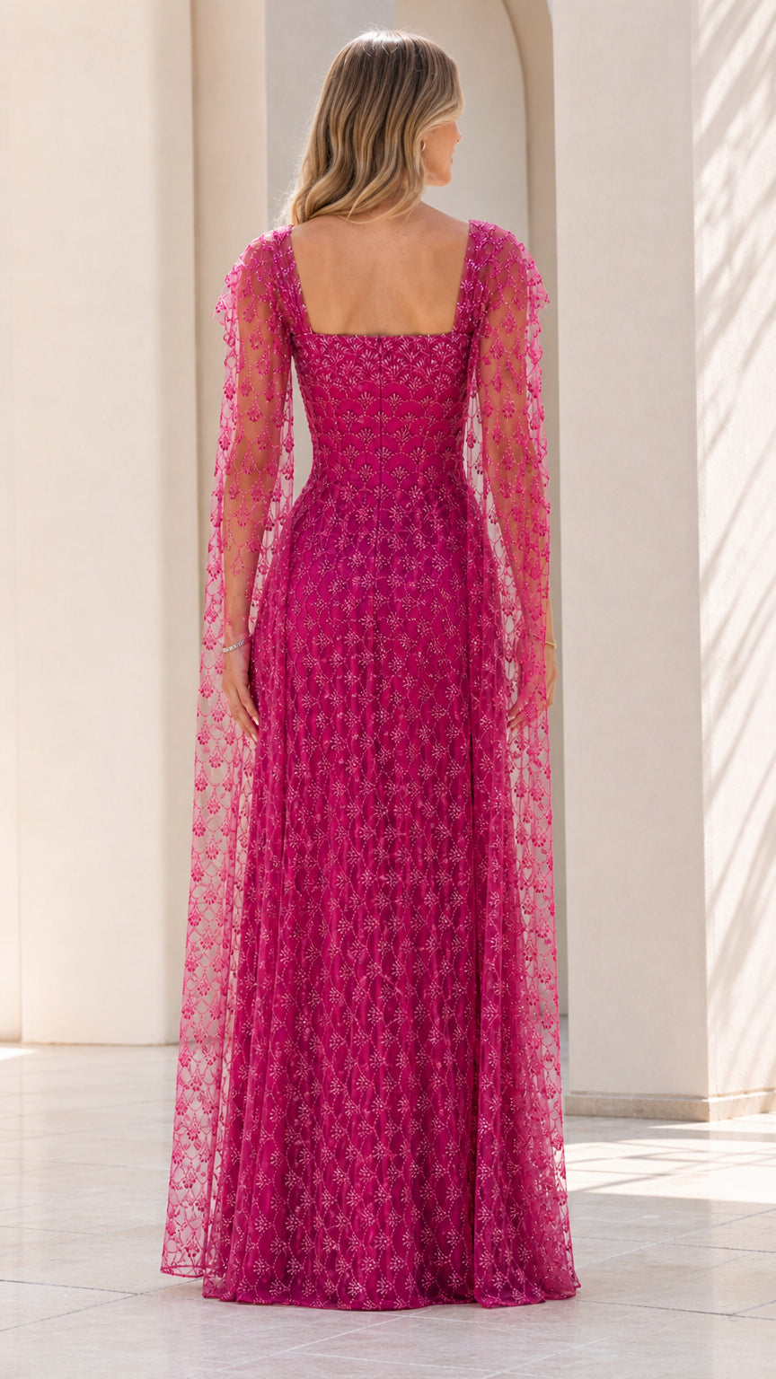 Back view of fuchsia evening dress with cape overlay