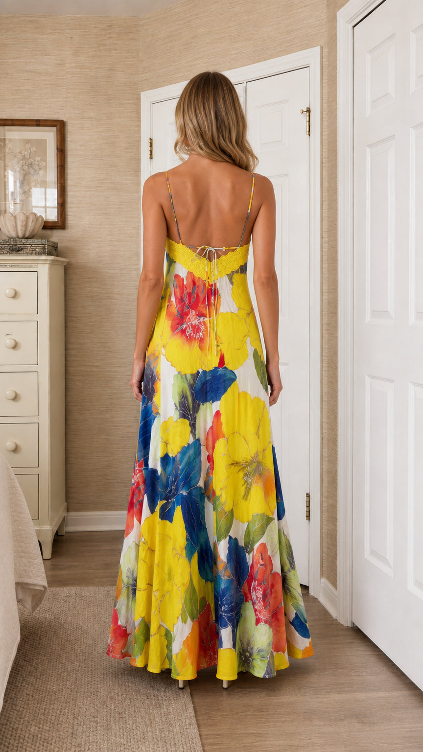 Back view of model wearing bright yellow floral maxi dress