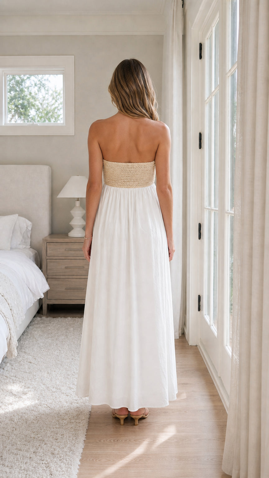 Back view of woman wearing white strapless maxi dress