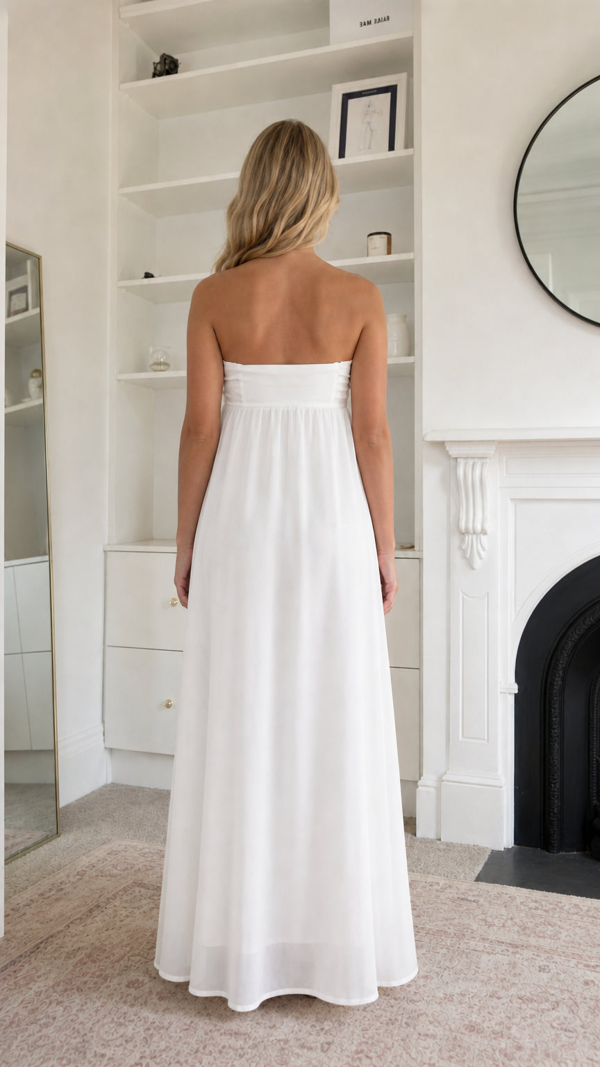 Back view of woman wearing white strapless maxi dress