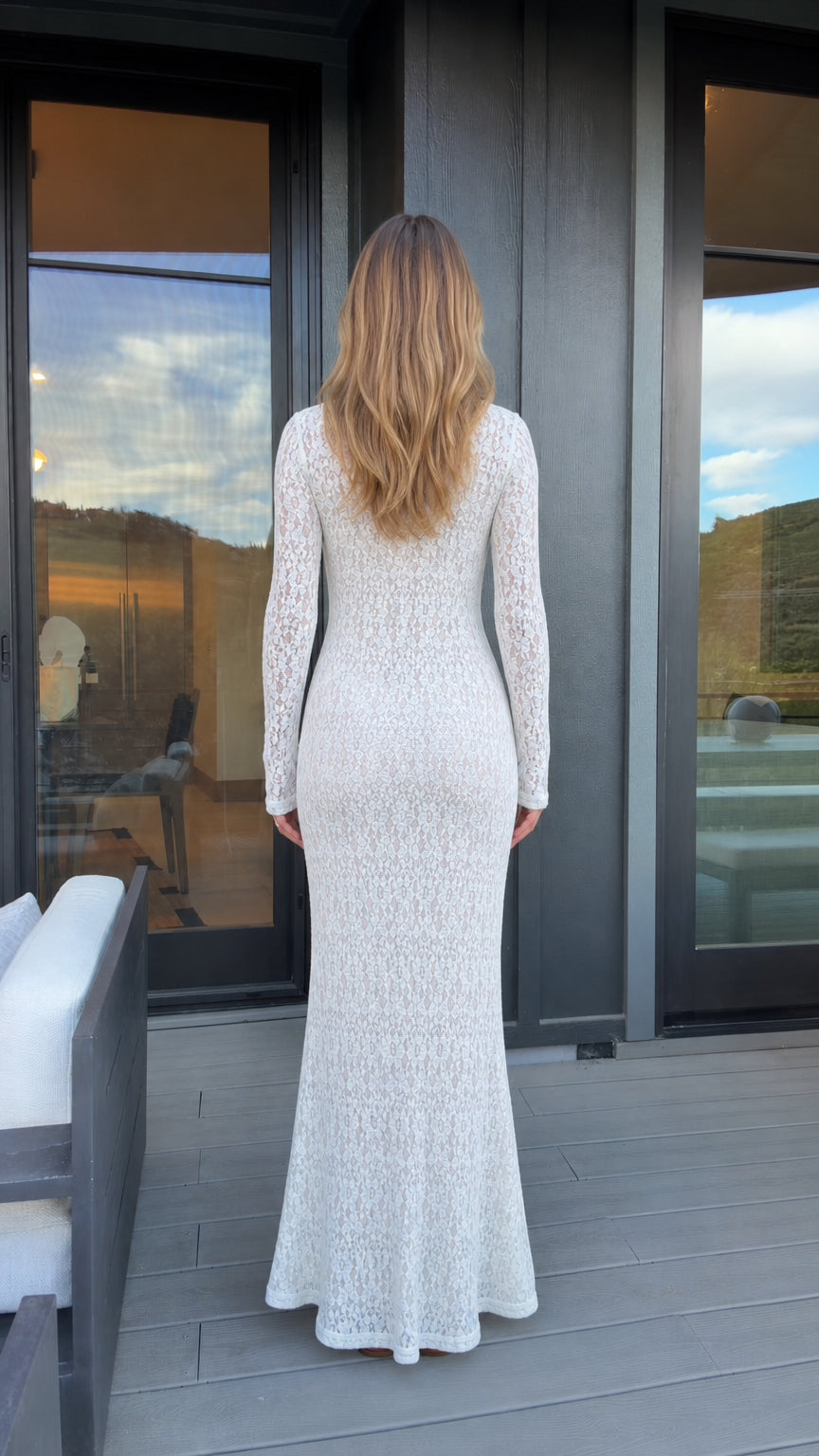 Back view of woman in white lace maxi dress