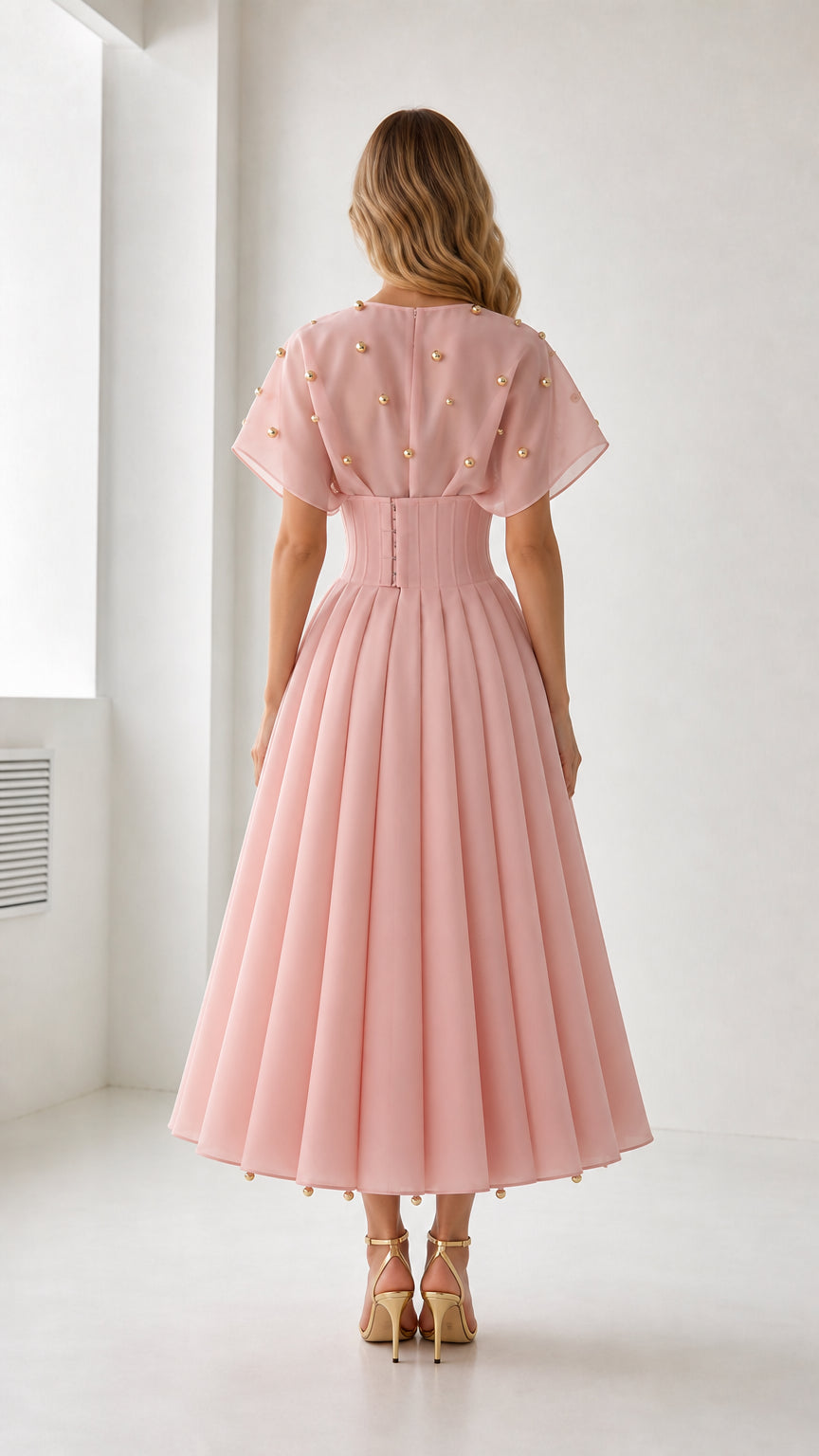 Back view of pink midi dress with pleated skirt details