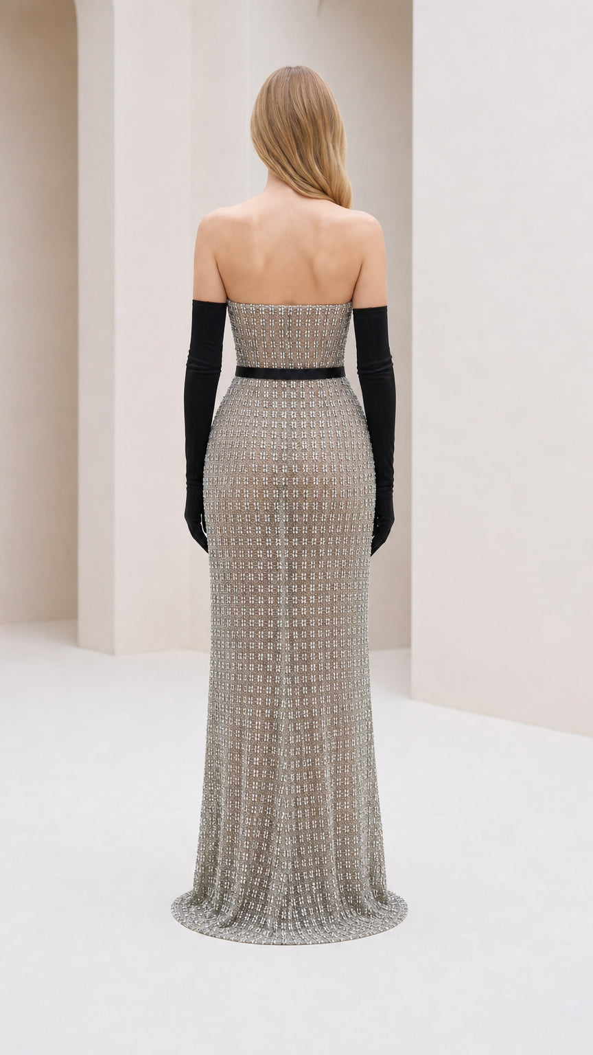 Back view of model in silver glitter strapless evening gown