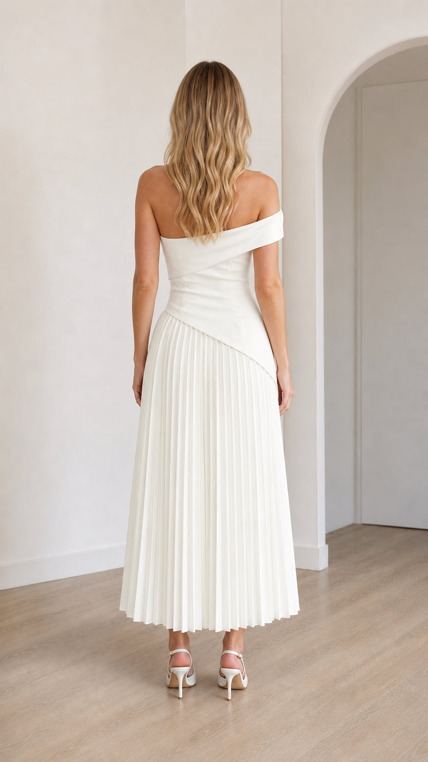 Back view of model in white off-shoulder midi dress