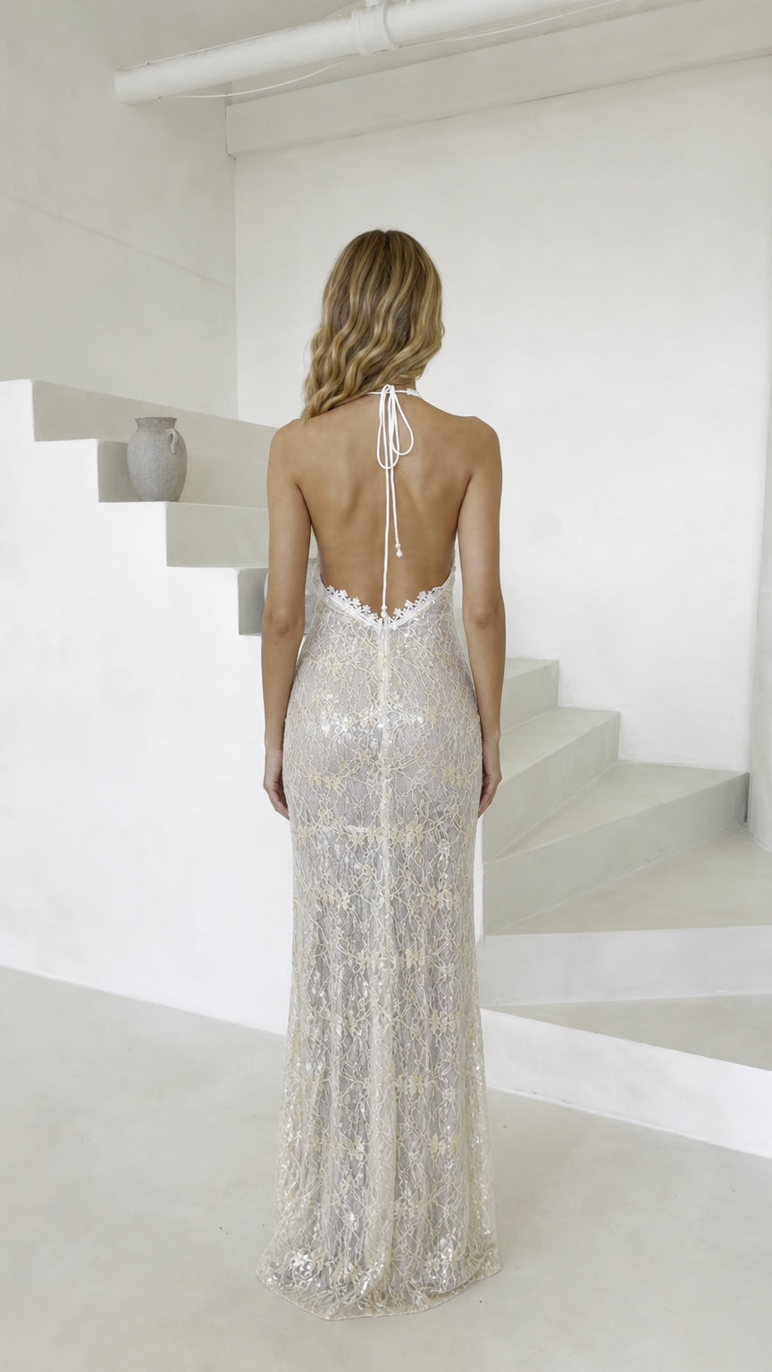 Back view showing open back and tie details of champagne dress