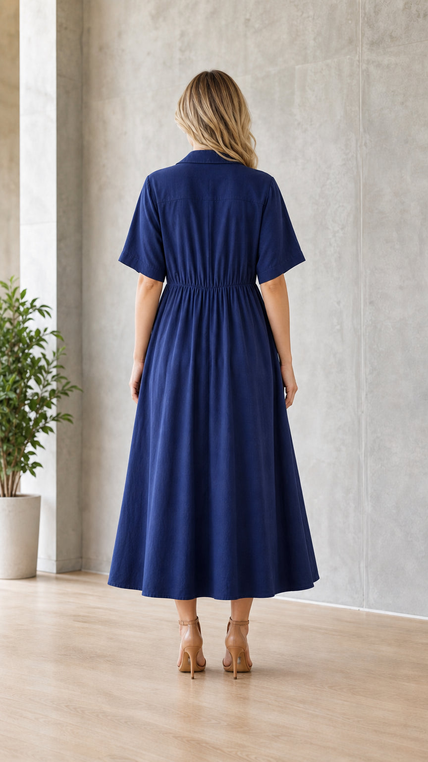 Woman wearing navy blue utility midi shirt dress from the back