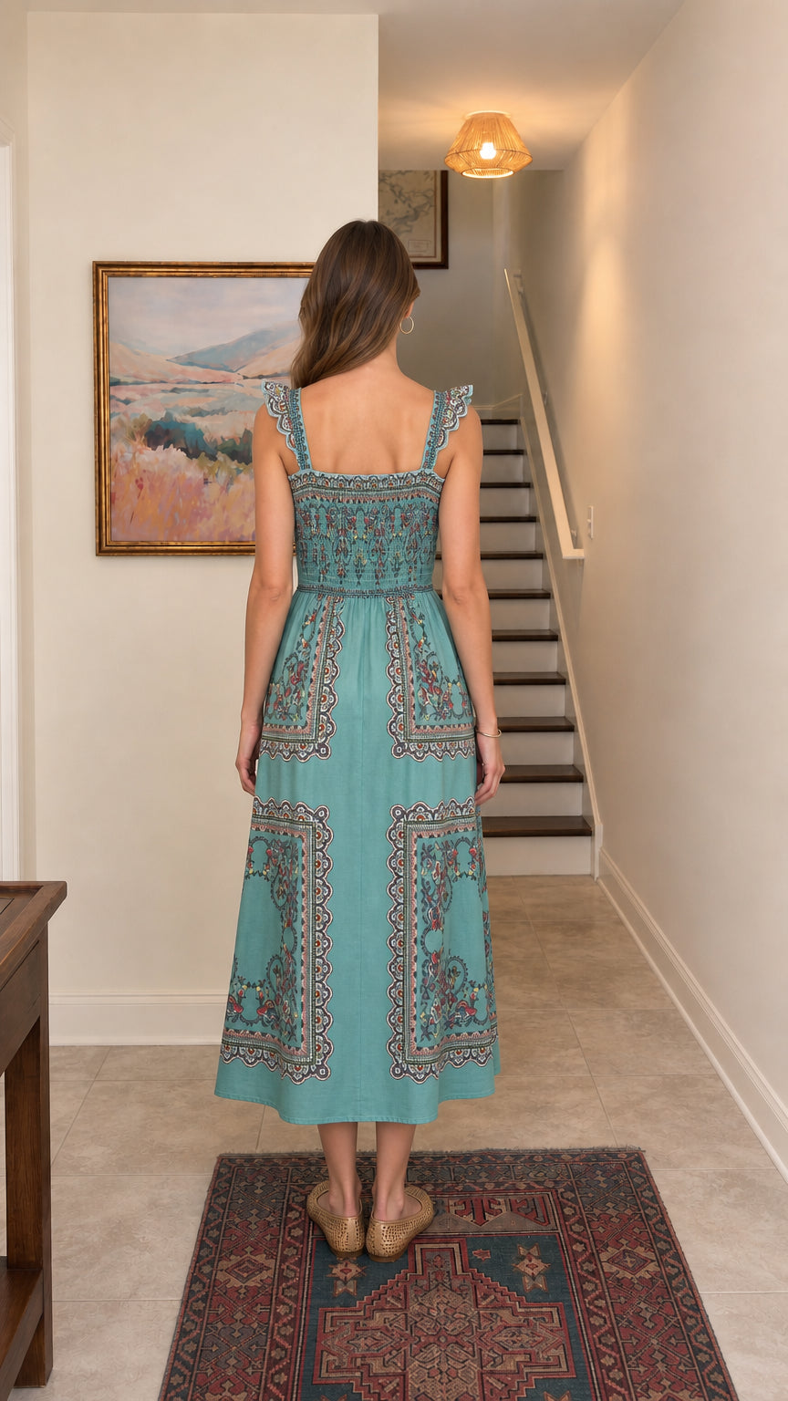 Back view showing smocked panel on teal midi dress