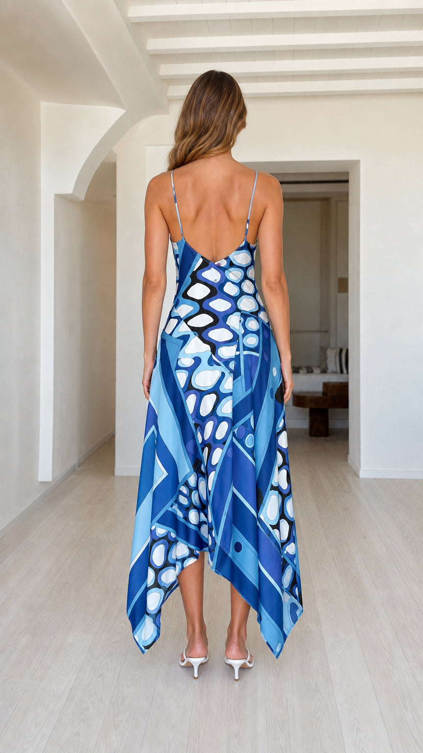 Model wearing blue geometric print slip dress back view
