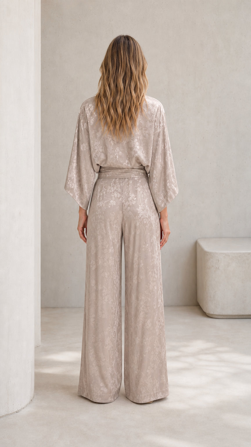 Back view of woman wearing champagne wide-leg jumpsuit