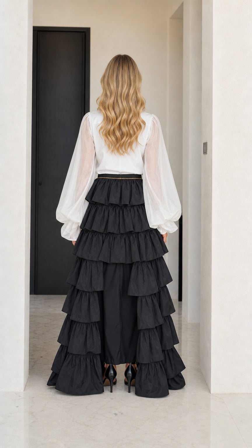 Back view of the dramatic tiered ruffle skirt and long-sleeve top