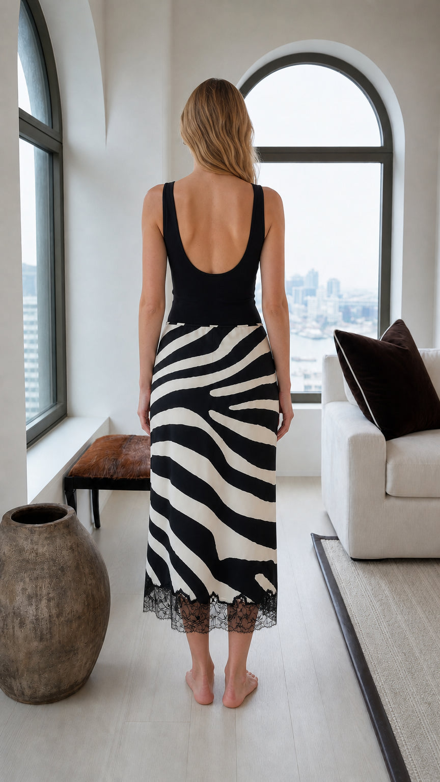 Back view of the black and white zebra print midi skirt with lace-trimmed hem