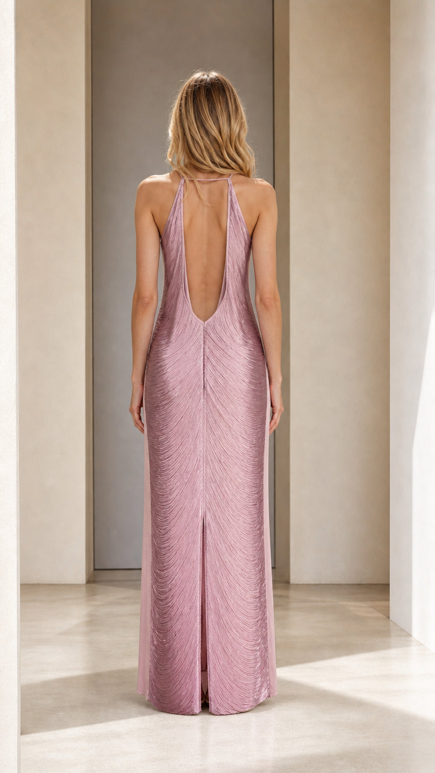 Back view of model showing open back design of mauve maxi dress