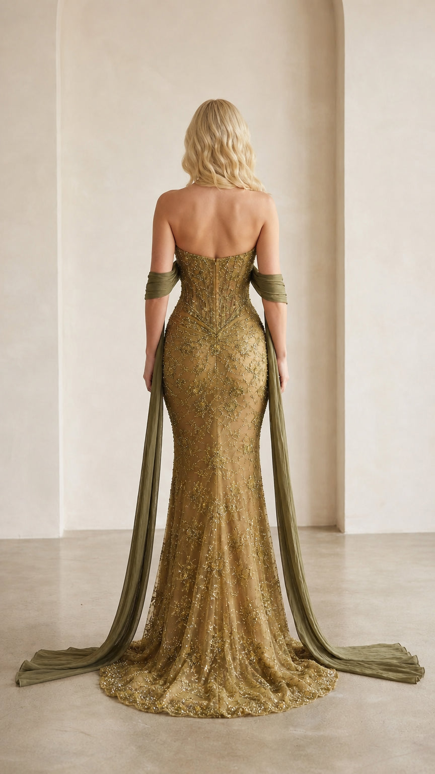 Back view of gold evening gown with sweep train and draped scarf