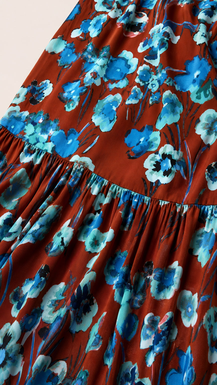 Close-up detail of rust and blue floral fabric and tiered seam