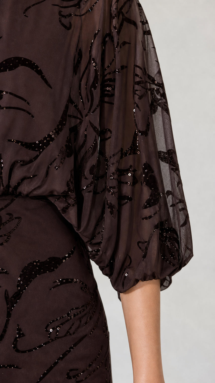 Close-up of sleeve and sequin fabric detail on Dark Brown dress